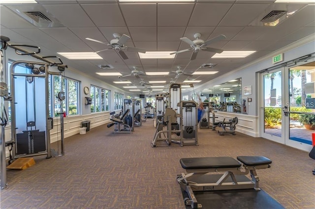 5866 Guarino Dr, Sarasota, FL 34238 - exercise room featuring carpet flooring, a ceiling fan, ornamental molding, a wainscoted wall, and a paneled ceiling