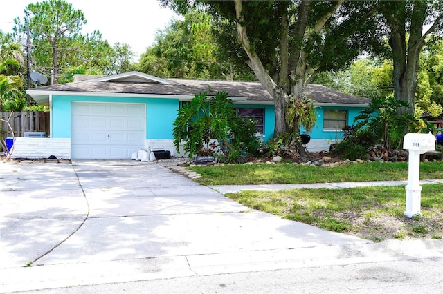 1099 6th Ave NE, Largo, FL 33770 - ranch-style house featuring driveway and an attached garage