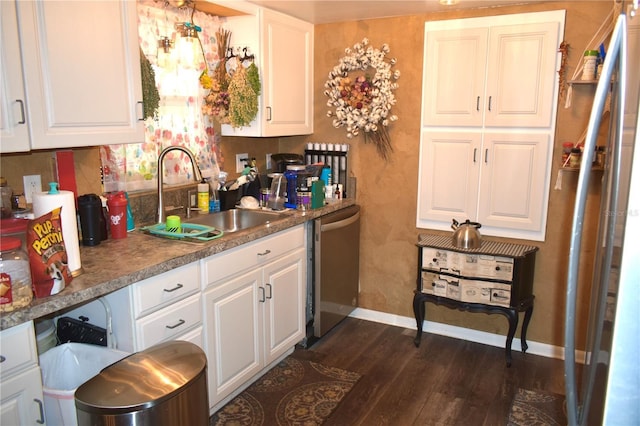 1099 6th Ave NE, Largo, FL 33770 - kitchen featuring dishwasher, a sink, dark wood-style floors, baseboards, and white cabinets