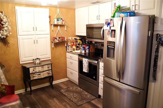 1099 6th Ave NE, Largo, FL 33770 - kitchen featuring stainless steel appliances, dark wood finished floors, and white cabinets