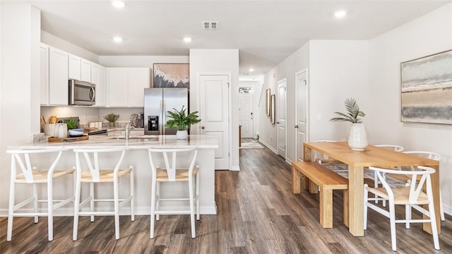 4326 Miller Point Ct, Bradenton, FL 34208 - kitchen featuring appliances with stainless steel finishes, a peninsula, dark wood-style flooring, a sink, and light countertops