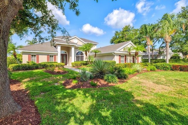 8930 Bloomfield Blvd, Sarasota, FL 34238 - view of front of home featuring stucco siding, a front yard, and a tile roof