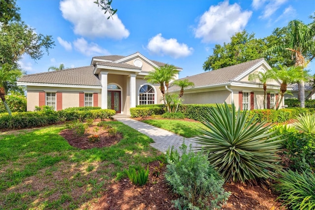 8930 Bloomfield Blvd, Sarasota, FL 34238 - greek revival house featuring a tiled roof and stucco siding