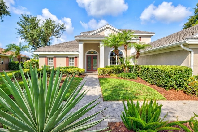 8930 Bloomfield Blvd, Sarasota, FL 34238 - view of front of house featuring french doors, stucco siding, and a tiled roof