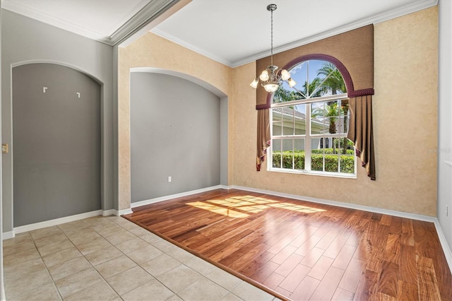 8930 Bloomfield Blvd, Sarasota, FL 34238 - unfurnished room featuring ornamental molding, plenty of natural light, arched walkways, a chandelier, and light wood-style flooring