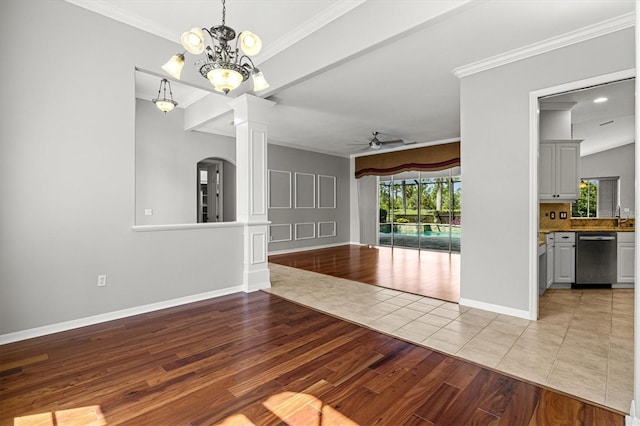 8930 Bloomfield Blvd, Sarasota, FL 34238 - unfurnished living room featuring decorative columns, a ceiling fan, light wood-type flooring, ornamental molding, and arched walkways