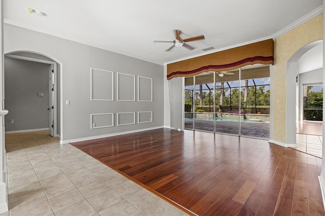 8930 Bloomfield Blvd, Sarasota, FL 34238 - tiled empty room with a ceiling fan, arched walkways, and ornamental molding
