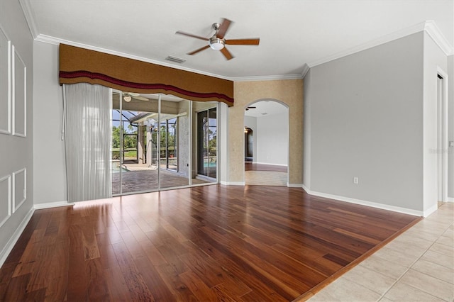 8930 Bloomfield Blvd, Sarasota, FL 34238 - empty room with ceiling fan, arched walkways, crown molding, and wood finished floors