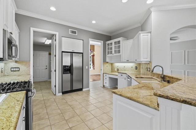 8930 Bloomfield Blvd, Sarasota, FL 34238 - kitchen featuring stainless steel appliances, arched walkways, light stone countertops, backsplash, and recessed lighting