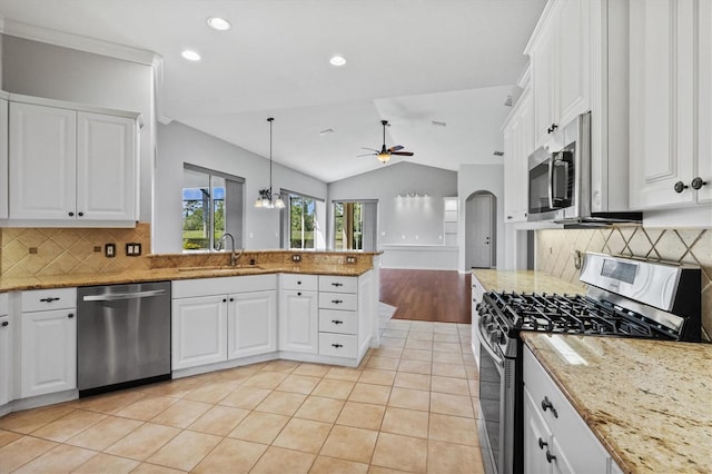 8930 Bloomfield Blvd, Sarasota, FL 34238 - kitchen featuring stainless steel appliances, ceiling fan, tasteful backsplash, a peninsula, and vaulted ceiling