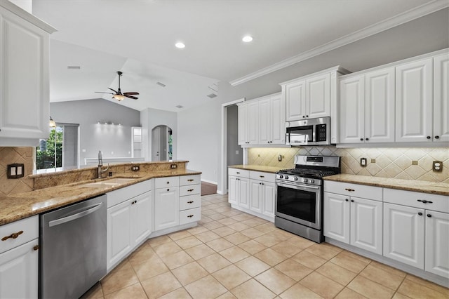 8930 Bloomfield Blvd, Sarasota, FL 34238 - kitchen featuring stainless steel appliances, a ceiling fan, light tile patterned floors, tasteful backsplash, and vaulted ceiling