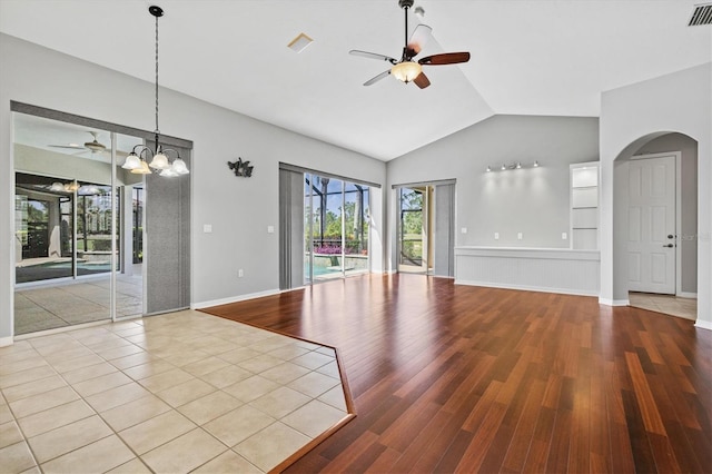 8930 Bloomfield Blvd, Sarasota, FL 34238 - unfurnished room featuring ceiling fan, arched walkways, lofted ceiling, and wood finished floors