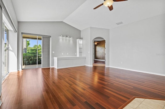 8930 Bloomfield Blvd, Sarasota, FL 34238 - unfurnished living room with ceiling fan, arched walkways, wood finished floors, and vaulted ceiling