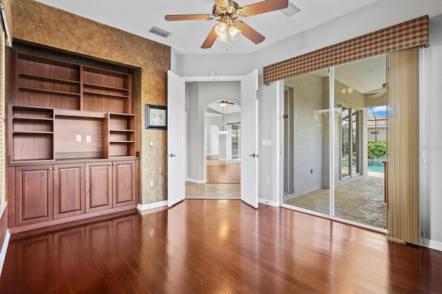 8930 Bloomfield Blvd, Sarasota, FL 34238 - unfurnished living room featuring arched walkways, a ceiling fan, and wood finished floors