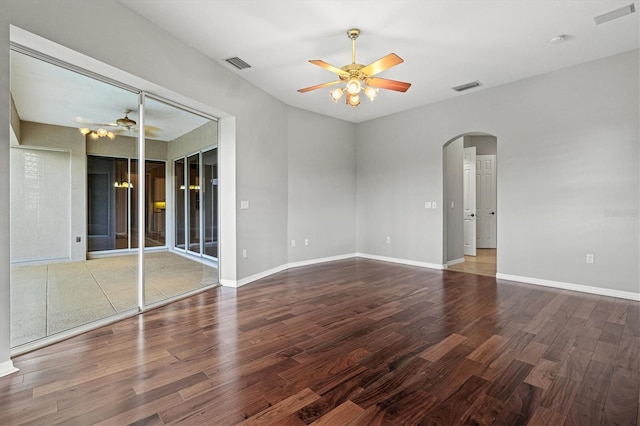 8930 Bloomfield Blvd, Sarasota, FL 34238 - unfurnished room featuring ceiling fan, arched walkways, wood finished floors, and a smoke detector