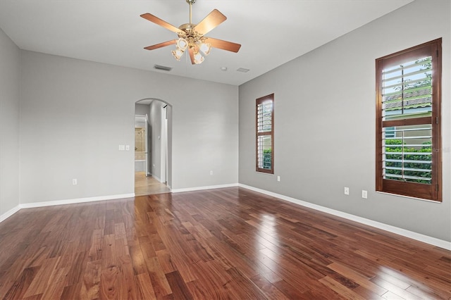 8930 Bloomfield Blvd, Sarasota, FL 34238 - empty room featuring arched walkways, wood finished floors, and a ceiling fan