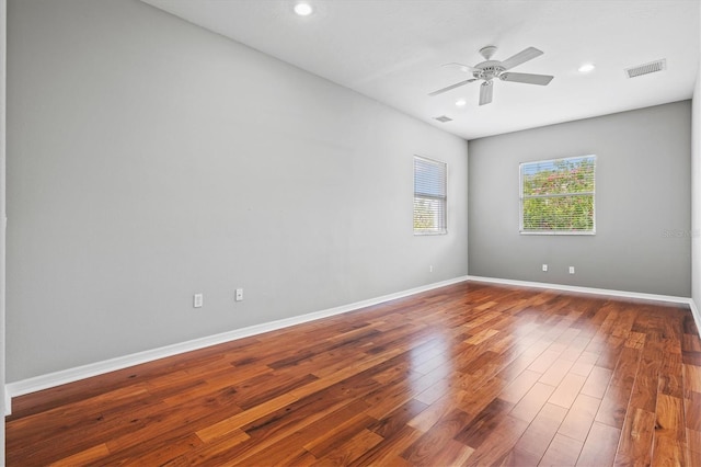 8930 Bloomfield Blvd, Sarasota, FL 34238 - empty room featuring dark wood finished floors, ceiling fan, and recessed lighting