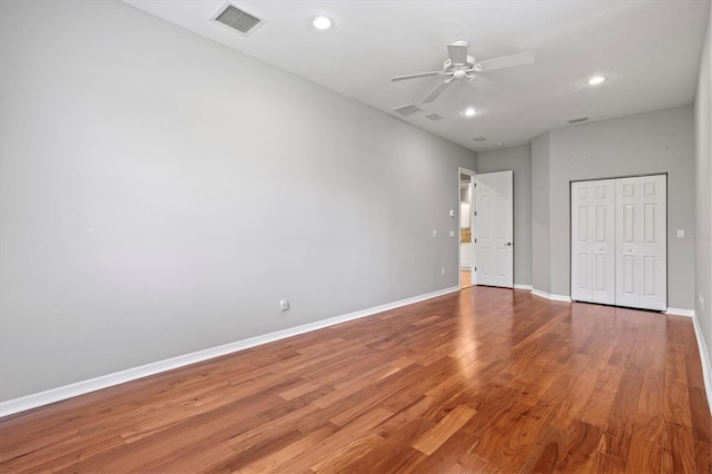 8930 Bloomfield Blvd, Sarasota, FL 34238 - unfurnished bedroom with light wood-style floors, a closet, recessed lighting, and a ceiling fan