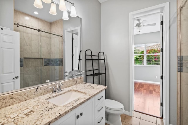 8930 Bloomfield Blvd, Sarasota, FL 34238 - bathroom with vanity, tiled shower, ceiling fan, and tile patterned floors