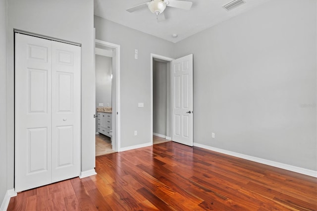 8930 Bloomfield Blvd, Sarasota, FL 34238 - unfurnished bedroom with wood finished floors, a closet, and a ceiling fan