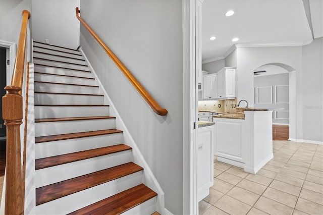 8930 Bloomfield Blvd, Sarasota, FL 34238 - stairs with arched walkways, tile patterned floors, crown molding, and recessed lighting