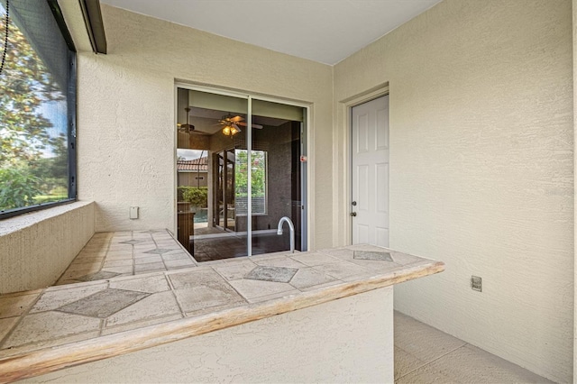 8930 Bloomfield Blvd, Sarasota, FL 34238 - doorway to property featuring stucco siding and a balcony