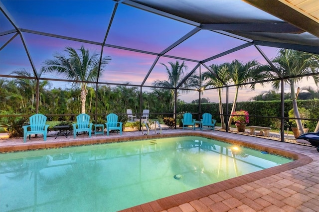 7913 19th Avenue Dr W, Bradenton, FL 34209 - pool at dusk with an outdoor pool, a patio area, and a lanai
