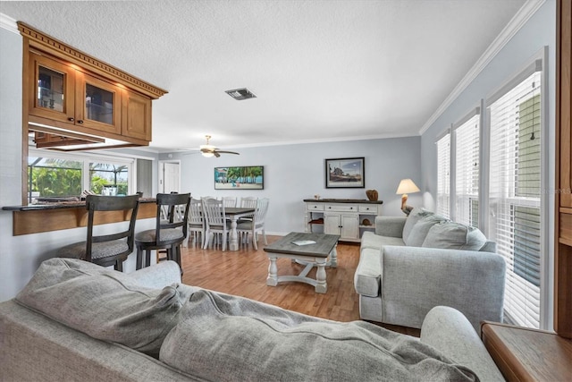 7913 19th Avenue Dr W, Bradenton, FL 34209 - living room featuring crown molding, wood finished floors, and ceiling fan