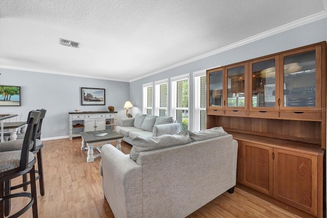 7913 19th Avenue Dr W, Bradenton, FL 34209 - living room featuring crown molding, light wood-style flooring, and a textured ceiling