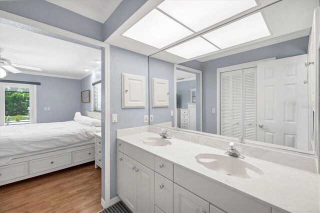 7913 19th Avenue Dr W, Bradenton, FL 34209 - bathroom featuring double vanity, a closet, wood finished floors, connected bathroom, and a ceiling fan
