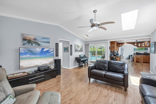 7913 19th Avenue Dr W, Bradenton, FL 34209 - living area featuring light wood-style floors, arched walkways, a ceiling fan, vaulted ceiling, and ornamental molding
