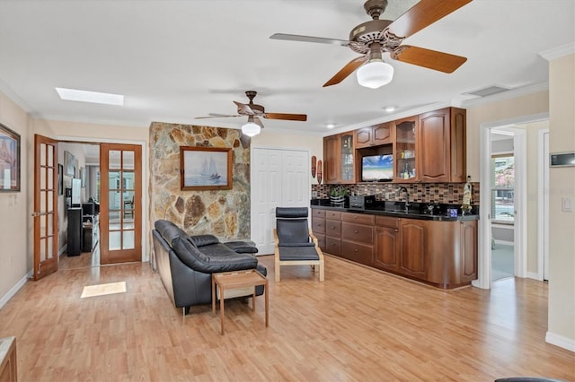 7913 19th Avenue Dr W, Bradenton, FL 34209 - living room featuring french doors, light wood-style floors, crown molding, and ceiling fan
