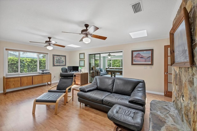 7913 19th Avenue Dr W, Bradenton, FL 34209 - living area with a skylight, ceiling fan, light wood-style flooring, and healthy amount of natural light