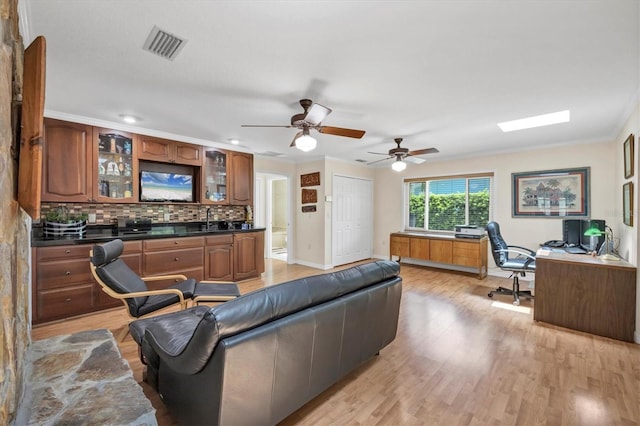 7913 19th Avenue Dr W, Bradenton, FL 34209 - living area with a desk, light wood-style floors, ceiling fan, and crown molding