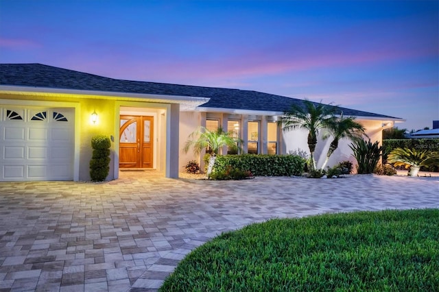 7913 19th Avenue Dr W, Bradenton, FL 34209 - ranch-style house featuring stucco siding, a garage, and driveway