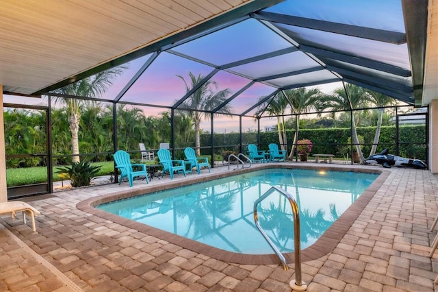 7913 19th Avenue Dr W, Bradenton, FL 34209 - pool at dusk featuring an outdoor pool, a patio area, and a lanai