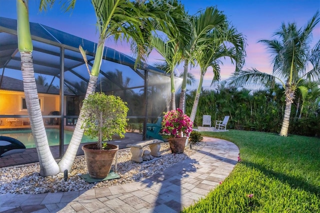 7913 19th Avenue Dr W, Bradenton, FL 34209 - patio terrace at dusk featuring an outdoor pool, a patio area, a lawn, and glass enclosure