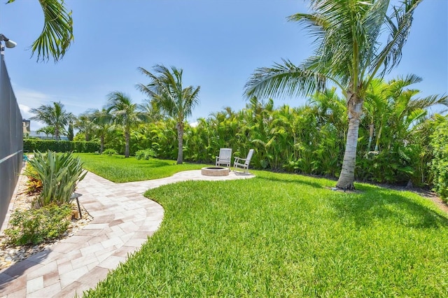 7913 19th Avenue Dr W, Bradenton, FL 34209 - view of grassy yard with a fire pit