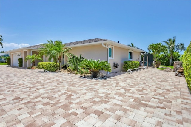 7913 19th Avenue Dr W, Bradenton, FL 34209 - view of front of home featuring an attached garage, stucco siding, and decorative driveway