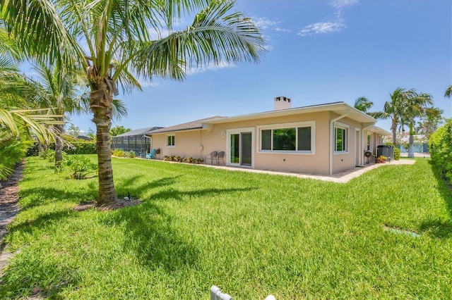 7913 19th Avenue Dr W, Bradenton, FL 34209 - rear view of property with stucco siding, a yard, a chimney, and a lanai