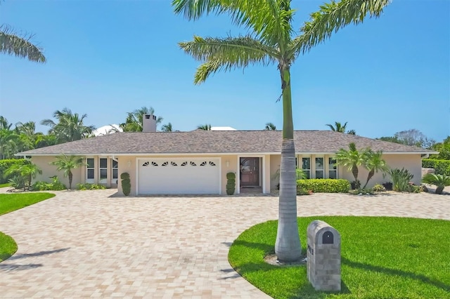 7913 19th Avenue Dr W, Bradenton, FL 34209 - ranch-style house featuring an attached garage, stucco siding, decorative driveway, and a front lawn