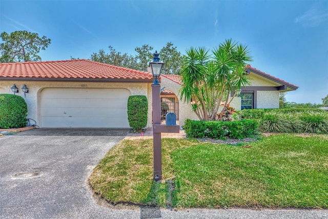 5651 Golf Pointe Dr Unit 5651, Sarasota, FL 34243 - mediterranean / spanish-style home featuring driveway, stucco siding, an attached garage, and a front yard