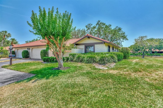 5651 Golf Pointe Dr Unit 5651, Sarasota, FL 34243 - ranch-style house featuring a garage, stucco siding, a front yard, asphalt driveway, and a tiled roof