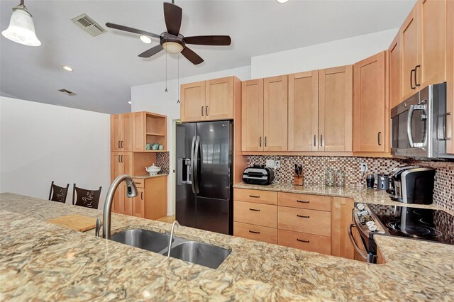 5651 Golf Pointe Dr Unit 5651, Sarasota, FL 34243 - kitchen featuring fridge with ice dispenser, stainless steel microwave, a sink, light stone countertops, and electric stove