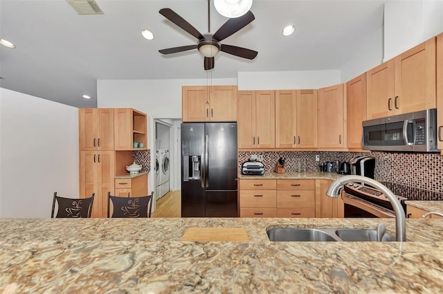 5651 Golf Pointe Dr Unit 5651, Sarasota, FL 34243 - kitchen with refrigerator with ice dispenser, stainless steel microwave, independent washer and dryer, a ceiling fan, and a sink