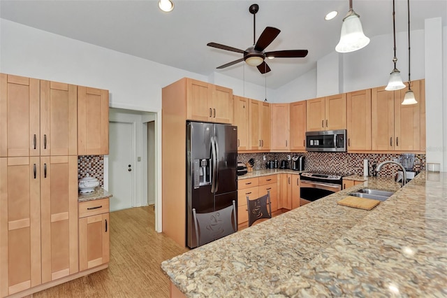 5651 Golf Pointe Dr Unit 5651, Sarasota, FL 34243 - kitchen featuring appliances with stainless steel finishes, a sink, light brown cabinets, a ceiling fan, and light stone counters