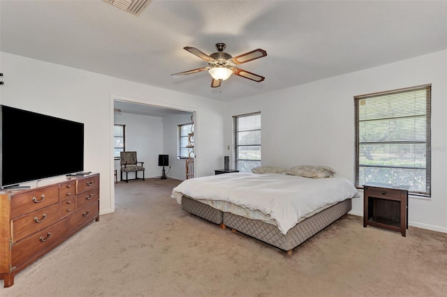 5651 Golf Pointe Dr Unit 5651, Sarasota, FL 34243 - bedroom featuring light colored carpet, multiple windows, and baseboards