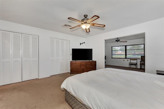 5651 Golf Pointe Dr Unit 5651, Sarasota, FL 34243 - bedroom featuring two closets, carpet floors, a ceiling fan, and baseboards