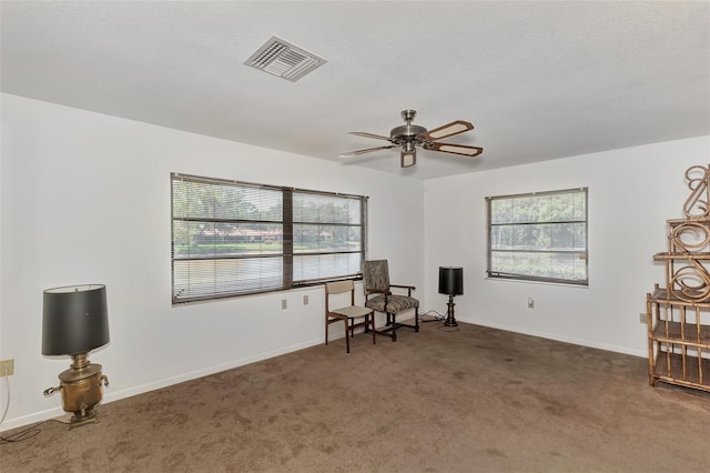 5651 Golf Pointe Dr Unit 5651, Sarasota, FL 34243 - sitting room featuring plenty of natural light, ceiling fan, carpet, and baseboards