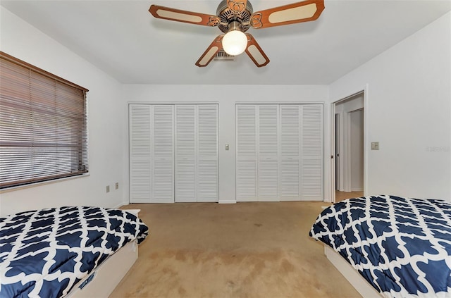 5651 Golf Pointe Dr Unit 5651, Sarasota, FL 34243 - bedroom with two closets, carpet floors, and ceiling fan